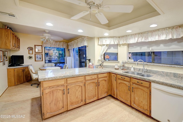 kitchen featuring a sink, a peninsula, recessed lighting, dishwasher, and a ceiling fan
