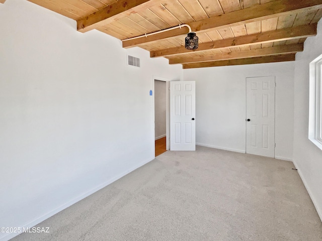 unfurnished room featuring wooden ceiling, light carpet, beamed ceiling, and visible vents