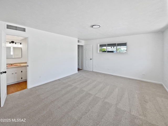 123 N Regency Pl, Tucson, AZ 85711 - interior space with baseboards, a sink, visible vents, and carpet