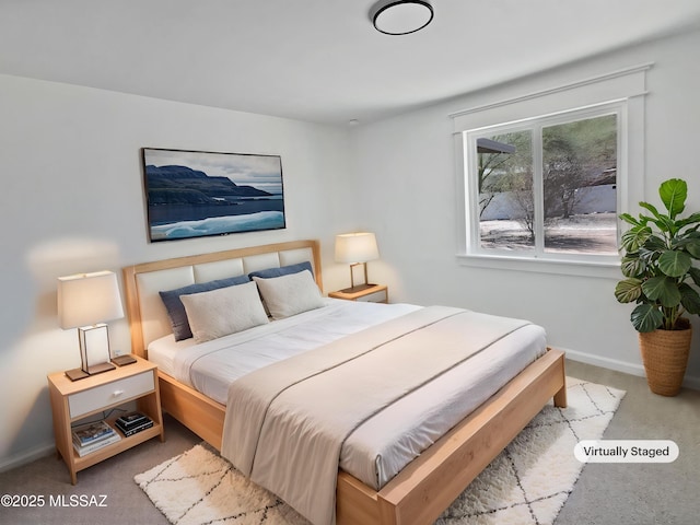 carpeted bedroom featuring baseboards