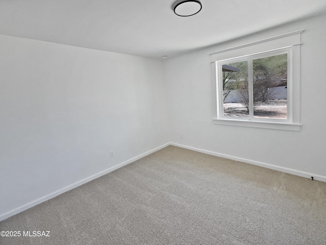 empty room with baseboards and carpet floors