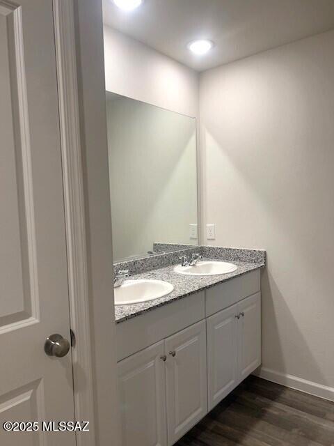 365 S Redwood Loop, Benson, AZ 85602 - bathroom featuring double vanity, wood finished floors, baseboards, and recessed lighting