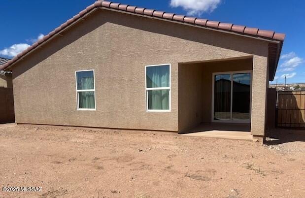 365 S Redwood Loop, Benson, AZ 85602 - back of house featuring stucco siding, a tile roof, fence, and a patio area