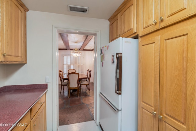 1047 E Hedrick Dr, Tucson, AZ 85719 - kitchen featuring freestanding refrigerator, a chandelier, beamed ceiling, and dark countertops
