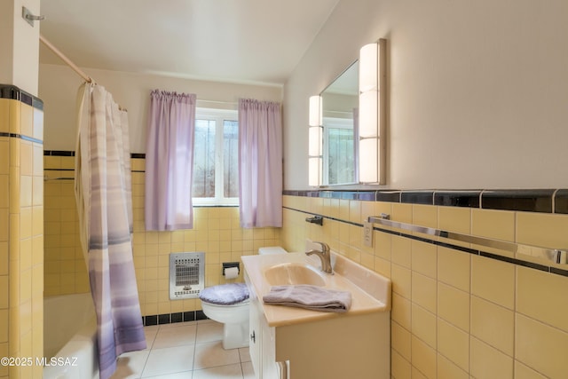 1047 E Hedrick Dr, Tucson, AZ 85719 - full bathroom featuring heating unit, toilet, vanity, tile patterned flooring, and shower / bath combo with shower curtain