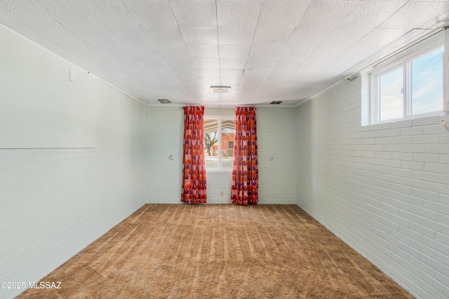 1047 E Hedrick Dr, Tucson, AZ 85719 - carpeted spare room featuring brick wall