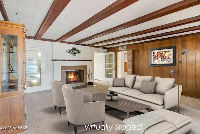 1047 E Hedrick Dr, Tucson, AZ 85719 - carpeted living area featuring beam ceiling, a glass covered fireplace, and wooden walls
