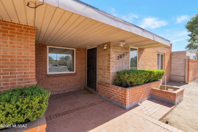 1047 E Hedrick Dr, Tucson, AZ 85719 - property entrance featuring brick siding