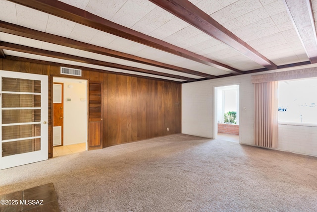 1047 E Hedrick Dr, Tucson, AZ 85719 - unfurnished room with beam ceiling, carpet flooring, and wooden walls