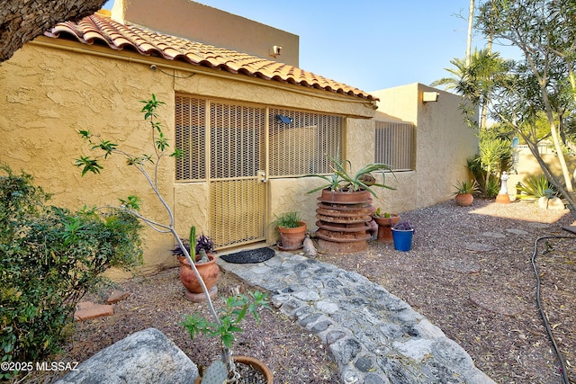810 E Placita Leslie, Tucson, AZ 85718 - view of home's exterior featuring stucco siding and a tile roof