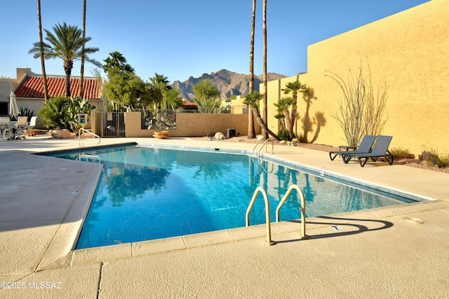 810 E Placita Leslie, Tucson, AZ 85718 - community pool featuring a patio, a mountain view, and fence