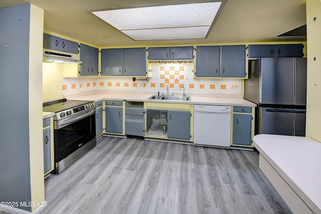 810 E Placita Leslie, Tucson, AZ 85718 - kitchen with light wood-type flooring, appliances with stainless steel finishes, blue cabinetry, and a sink