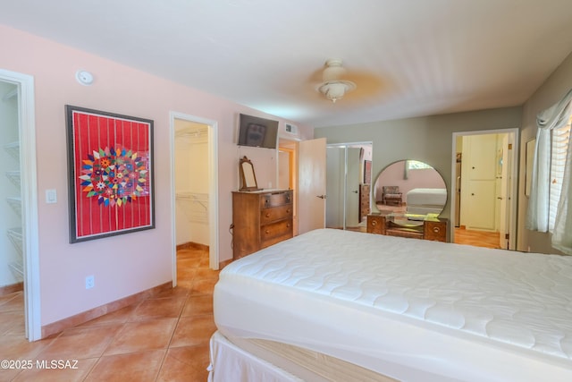 149 E Los Arcos, Green Valley, AZ 85614 - bedroom with a closet, visible vents, a spacious closet, light tile patterned floors, and baseboards