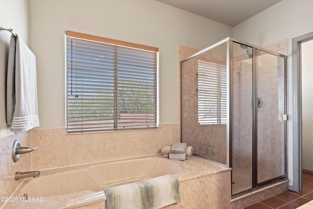 full bath featuring a shower stall, a garden tub, and tile patterned flooring