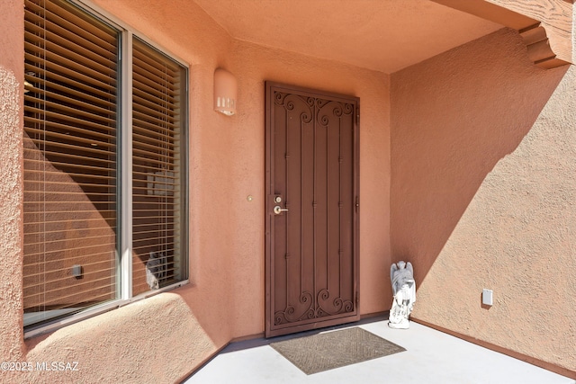 property entrance featuring stucco siding