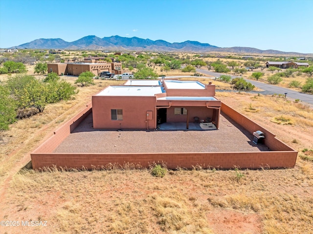 view of subject property with mountains and a desert landscape