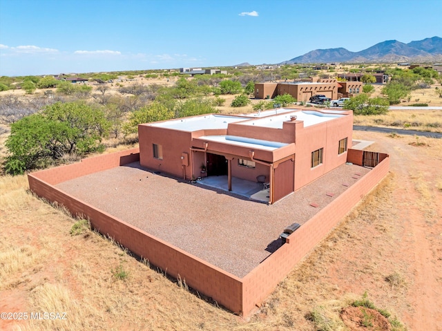aerial view of property and surrounding area with a mountain backdrop