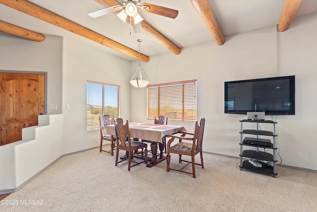 dining area with carpet, beamed ceiling, baseboards, and ceiling fan