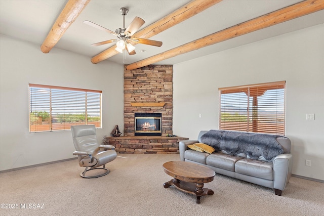 living room featuring beam ceiling, carpet flooring, a ceiling fan, and plenty of natural light