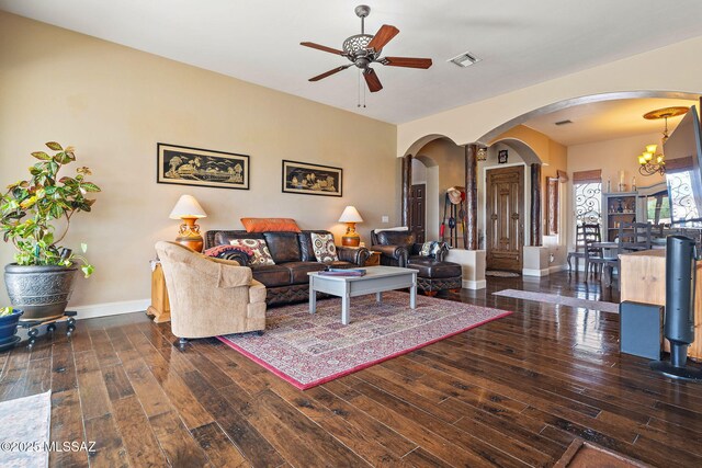 33 Camino Olympia, Rio Rico, AZ 85648 - living room with arched walkways, ceiling fan, wood-type flooring, baseboards, and a chandelier