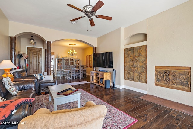 33 Camino Olympia, Rio Rico, AZ 85648 - living room featuring arched walkways, a ceiling fan, ornate columns, hardwood / wood-style floors, and a chandelier