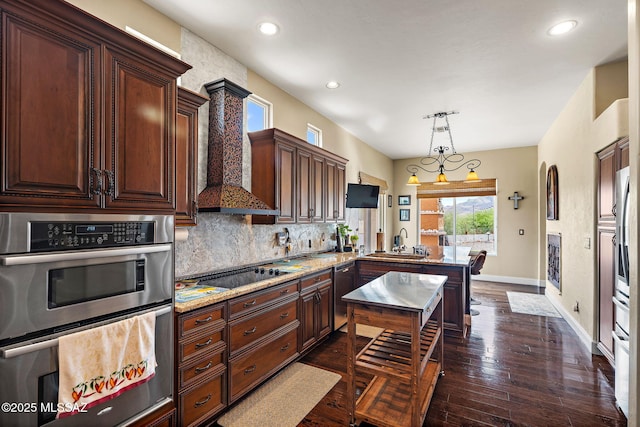 33 Camino Olympia, Rio Rico, AZ 85648 - kitchen with appliances with stainless steel finishes, a sink, a peninsula, tasteful backsplash, and baseboards
