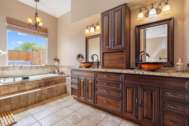 33 Camino Olympia, Rio Rico, AZ 85648 - full bathroom featuring tile patterned flooring, a garden tub, double vanity, and a chandelier