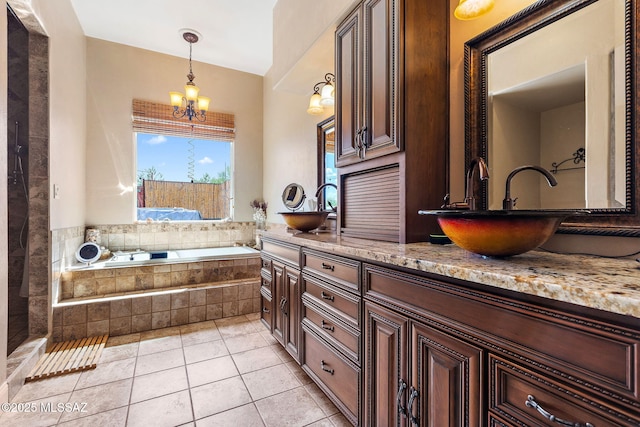 33 Camino Olympia, Rio Rico, AZ 85648 - bathroom featuring a chandelier, a bath, tile patterned flooring, and double vanity