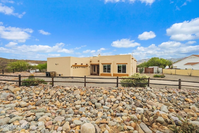 33 Camino Olympia, Rio Rico, AZ 85648 - view of front of home with stucco siding, a garage, and a mountain view