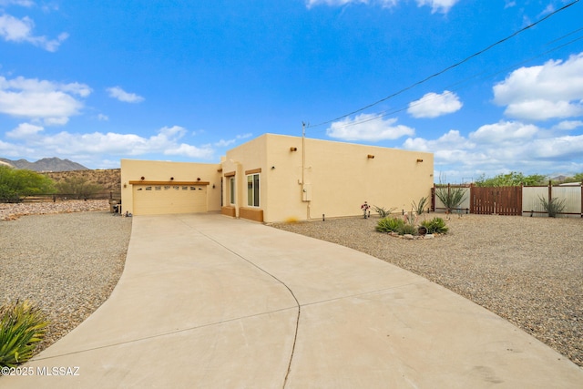 33 Camino Olympia, Rio Rico, AZ 85648 - view of front of house with driveway, stucco siding, a gate, fence, and a garage