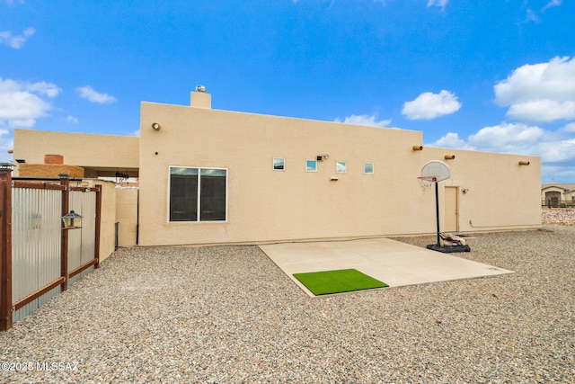 33 Camino Olympia, Rio Rico, AZ 85648 - rear view of property featuring stucco siding, a gate, fence, and a chimney