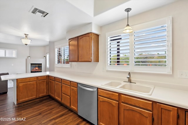 11846 N Copper Butte Dr, Oro Valley, AZ 85737 - kitchen featuring stainless steel dishwasher, a peninsula, a sink, a glass covered fireplace, and light countertops
