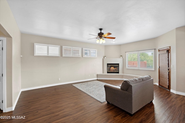 11846 N Copper Butte Dr, Oro Valley, AZ 85737 - living area featuring dark wood finished floors, a ceiling fan, baseboards, and a glass covered fireplace