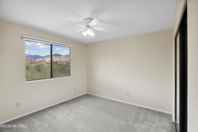 11846 N Copper Butte Dr, Oro Valley, AZ 85737 - unfurnished bedroom with carpet floors, baseboards, a mountain view, and a ceiling fan
