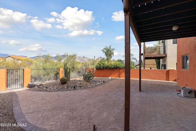 11846 N Copper Butte Dr, Oro Valley, AZ 85737 - view of patio with a fenced backyard, a gate, and a mountain view