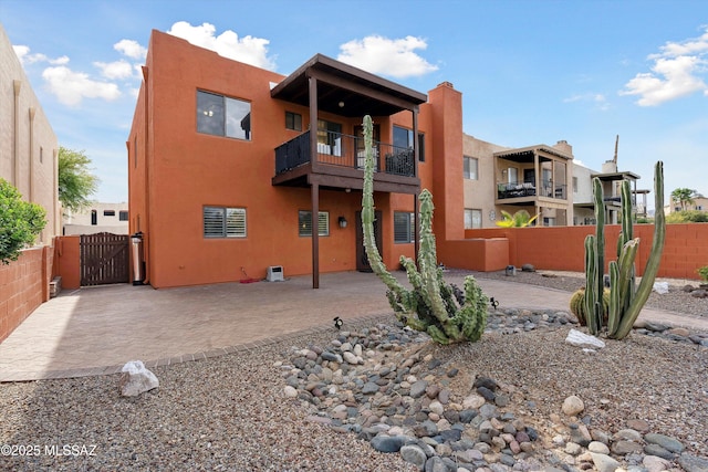 11846 N Copper Butte Dr, Oro Valley, AZ 85737 - rear view of property featuring a balcony, stucco siding, a gate, fence, and a patio