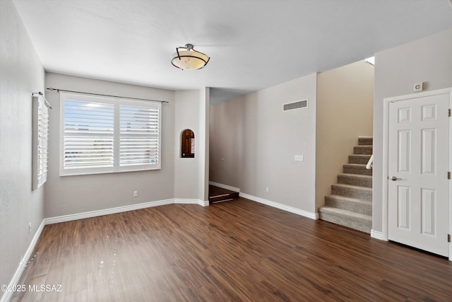 11846 N Copper Butte Dr, Oro Valley, AZ 85737 - unfurnished room with dark wood-style floors, stairs, and baseboards