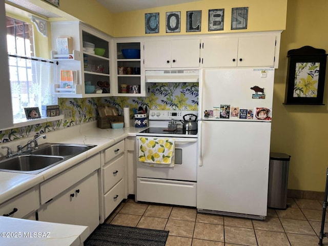 kitchen featuring under cabinet range hood, white appliances, a sink, light countertops, and white cabinets