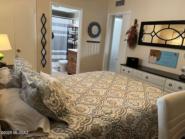 bedroom with ensuite bath and visible vents