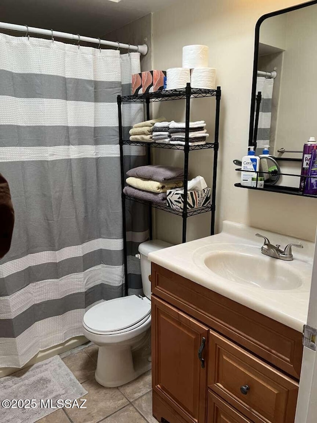 bathroom with tile patterned flooring, toilet, a shower with curtain, and vanity