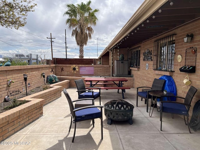 view of patio / terrace with a fire pit and a fenced backyard