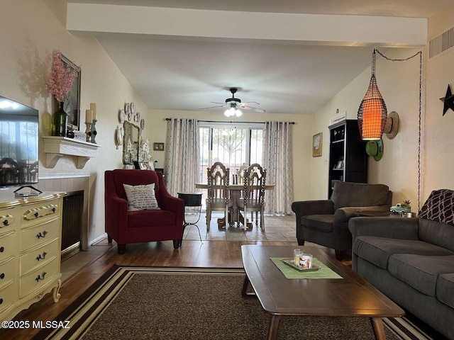 living area with wood finished floors and a ceiling fan