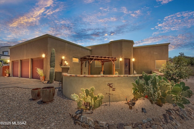 4544 N Camino Real, Tucson, AZ 85718 - pueblo-style home with driveway and an attached garage