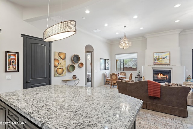 4544 N Camino Real, Tucson, AZ 85718 - kitchen with recessed lighting, light stone counters, hanging light fixtures, open floor plan, and arched walkways