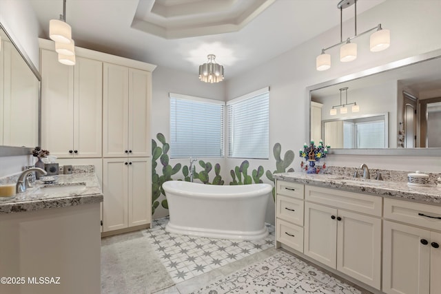 4544 N Camino Real, Tucson, AZ 85718 - full bathroom featuring a soaking tub, an inviting chandelier, two vanities, and a sink