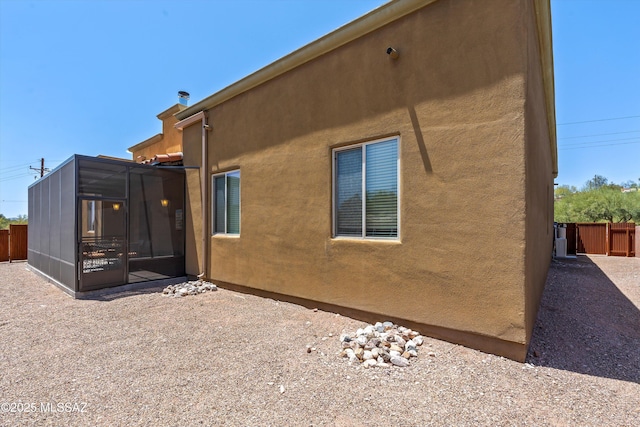 4544 N Camino Real, Tucson, AZ 85718 - back of house with a sunroom, stucco siding, and fence