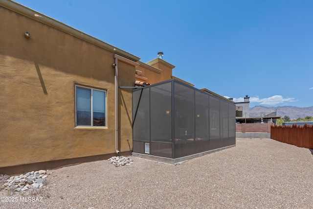 4544 N Camino Real, Tucson, AZ 85718 - back of property featuring a sunroom, a mountain view, and fence