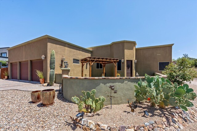 4544 N Camino Real, Tucson, AZ 85718 - pueblo-style house with fence, driveway, a garage, stucco siding, and a pergola