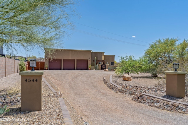 4544 N Camino Real, Tucson, AZ 85718 - southwest-style home featuring stucco siding, driveway, fence, and a garage