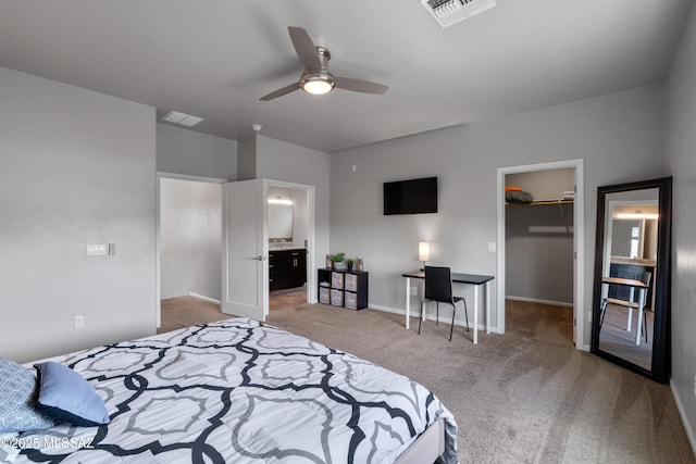 156 E Stone Ct, Tucson, AZ 85705 - carpeted bedroom featuring a walk in closet, a closet, baseboards, ensuite bath, and an office area